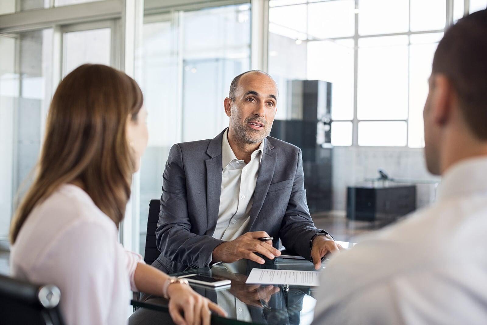 Financial adviser giving advice to clients