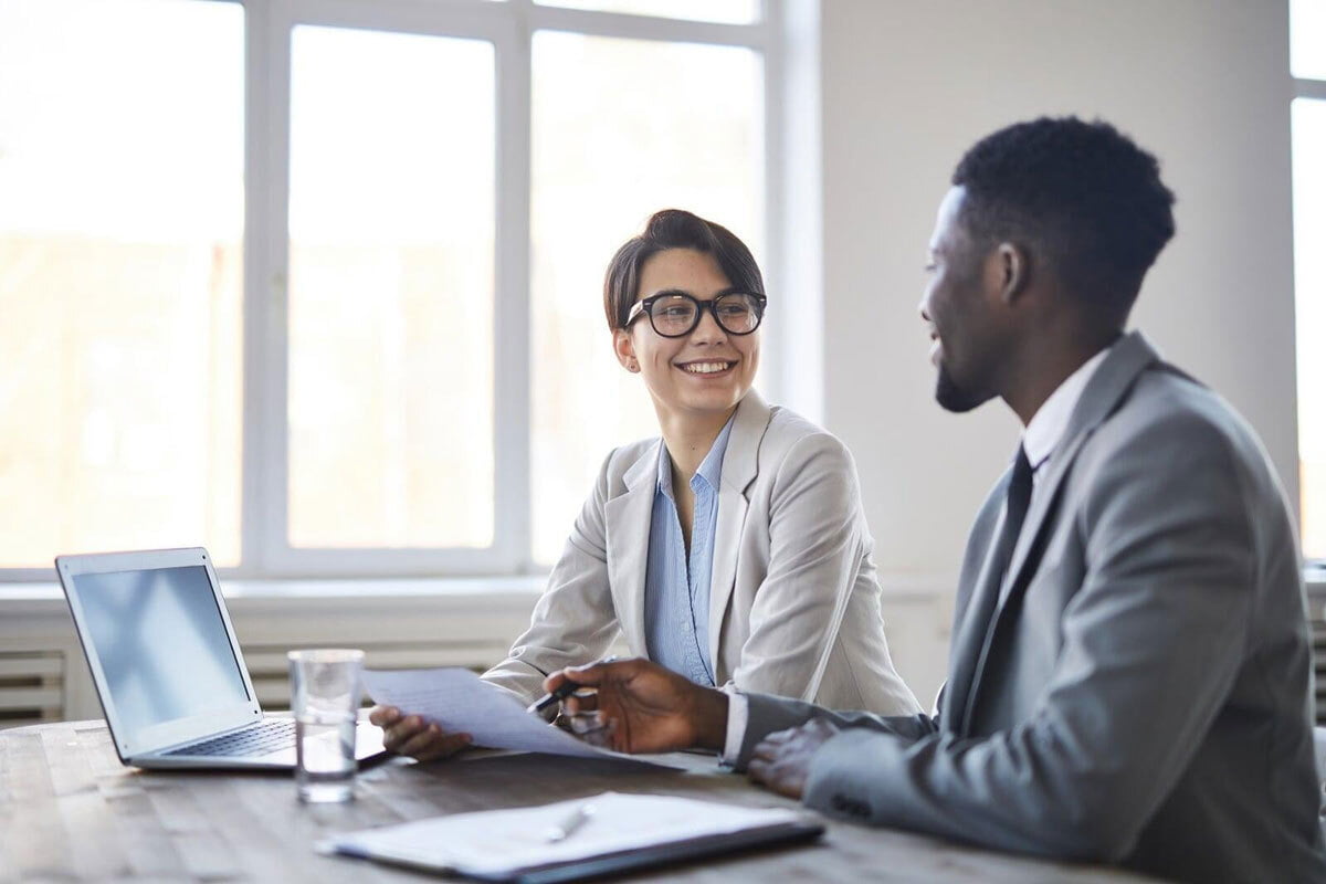 man and woman conducting a business file check in a modern office